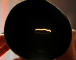 An inverted image of a hanging bulb through the pinhole camera.